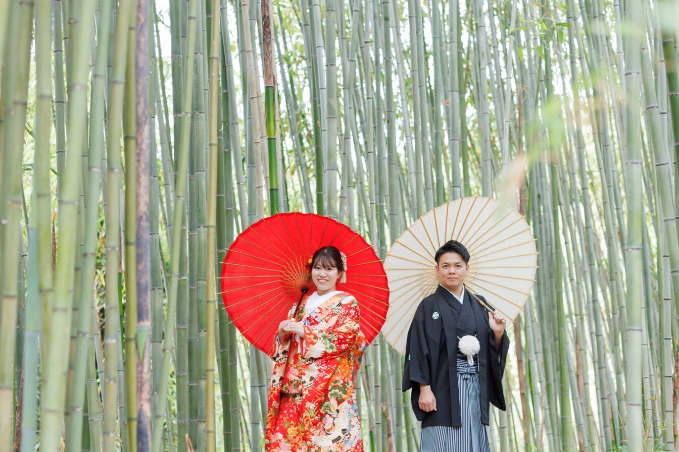 洛西竹林公園の竹林内で和傘を使って撮影を行う新郎新婦